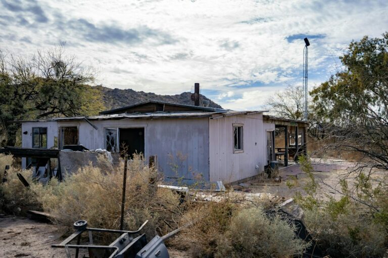 A single-story house surrounded by desert landscape