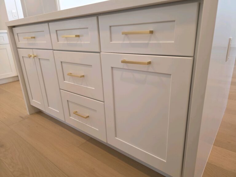 New white shaker kitchen cabinets with brass pulls in a remodeled Mesa flip