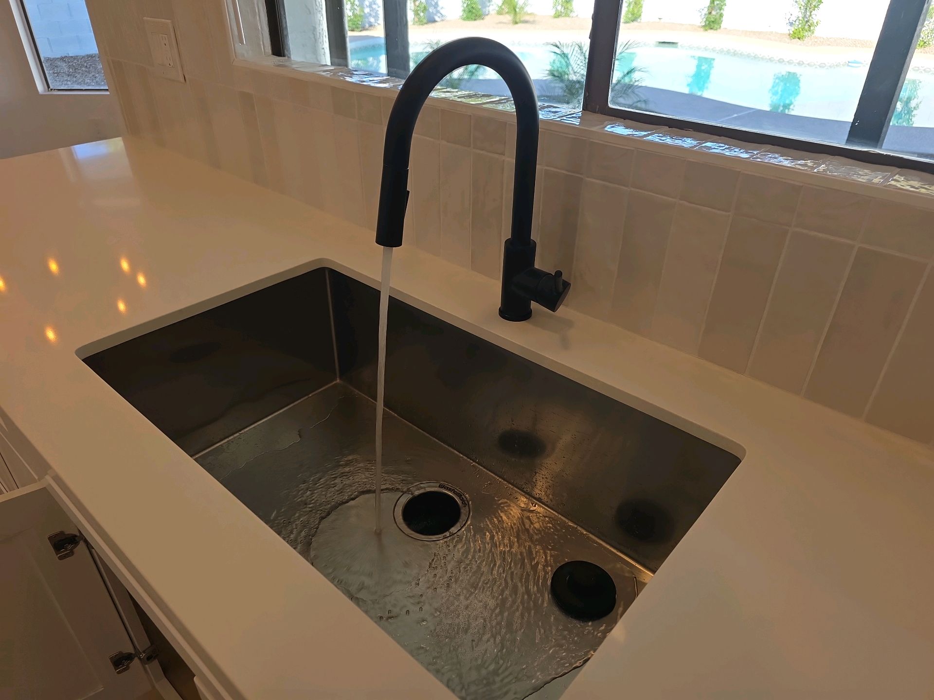 New kitchen sink and black faucet where the hot and cold lines were reversed