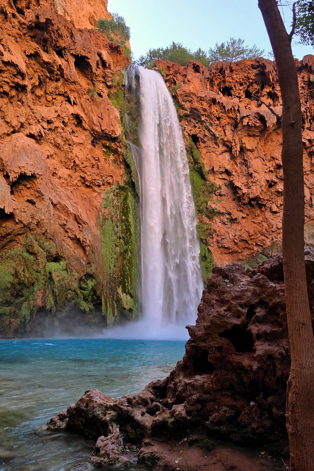 Turquoise blue water at the base of Mooney Falls in Havasupai, Arizona