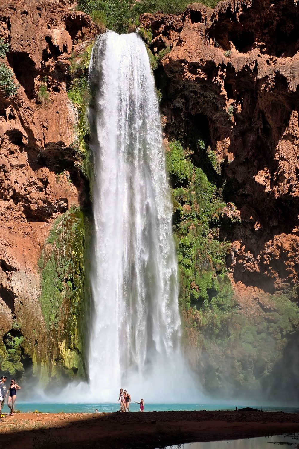 Mooney Falls pouring down red rock cliffs in Havasu Canyon, Havasupai, Arizona