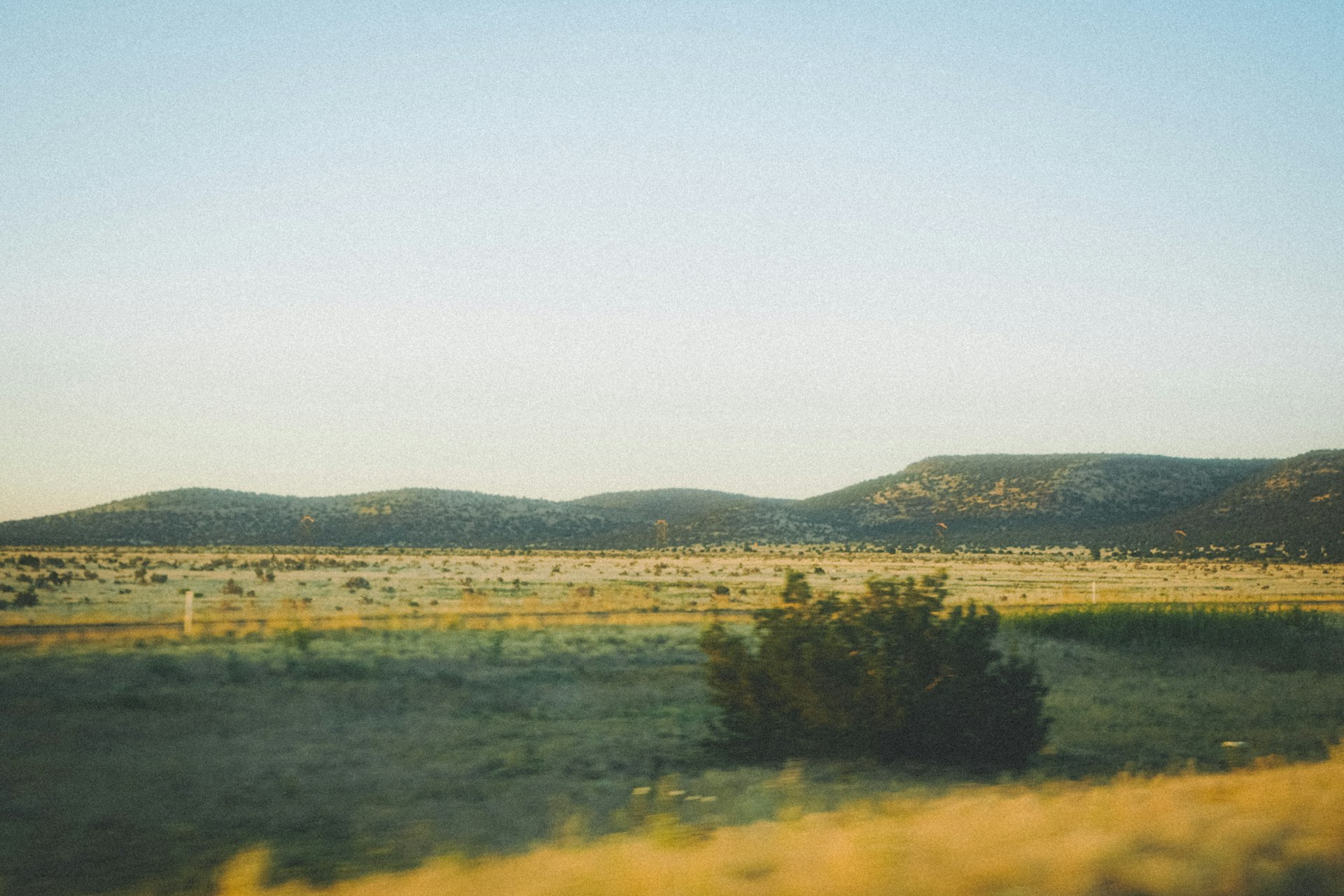 Sunlit open desert land with mountains in Arizona